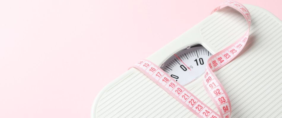 Scales And Measuring Tape On Pink Background. Weight Loss Concep Scales and measuring tape on pink background. Weight loss concept